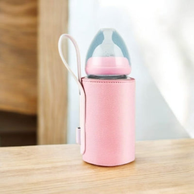 chauffe lait portable rose sur la table